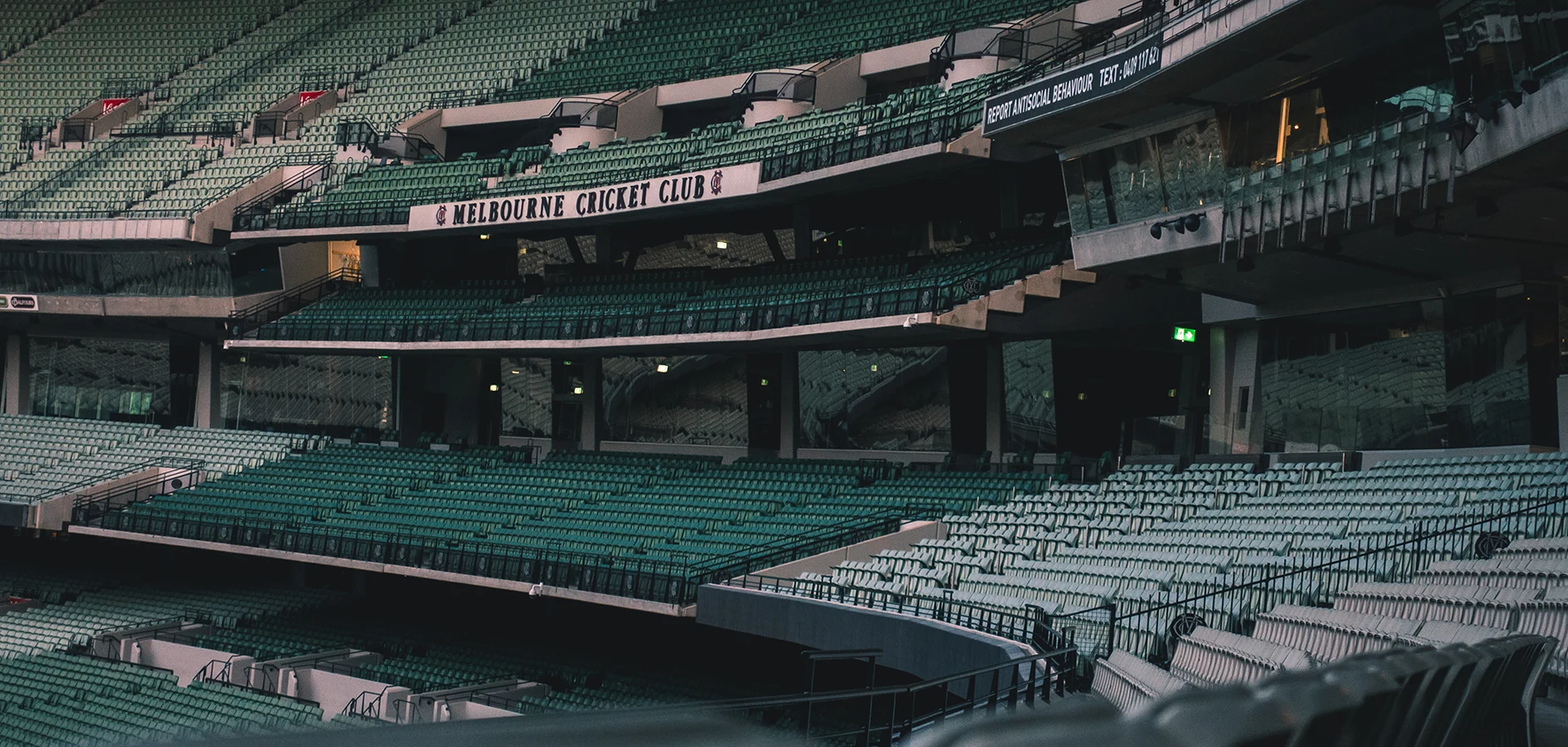 Empty green seating bowl with the Melbourne Cricket Club signage