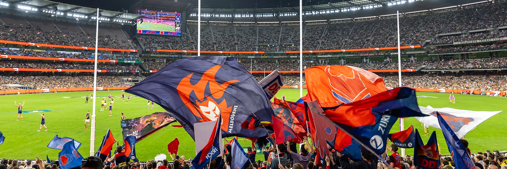 Melbourne cheer squad behind goalposts at MCG AFL match
