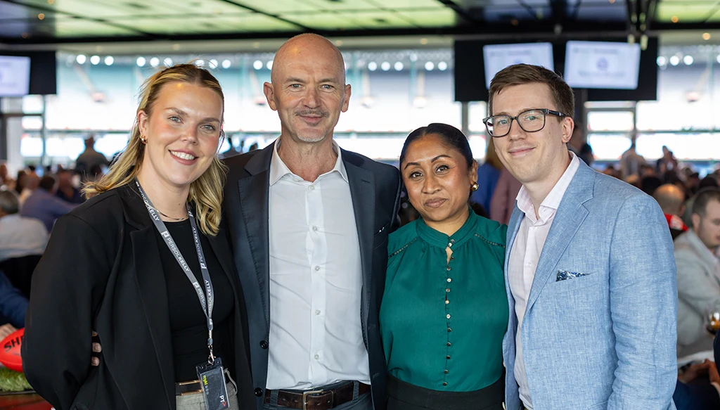 Four people in attire that meets the MCC dress standard with collared shirts or blouses