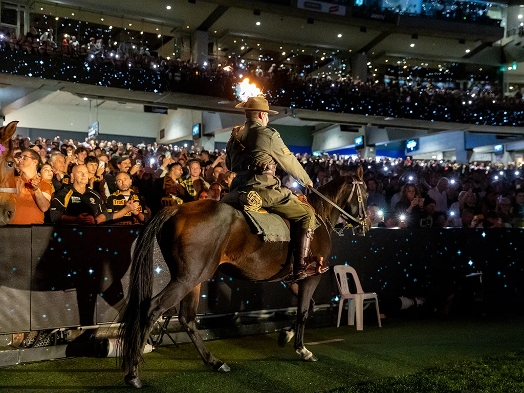 Eternal flame carried with MCG crowd in darkness