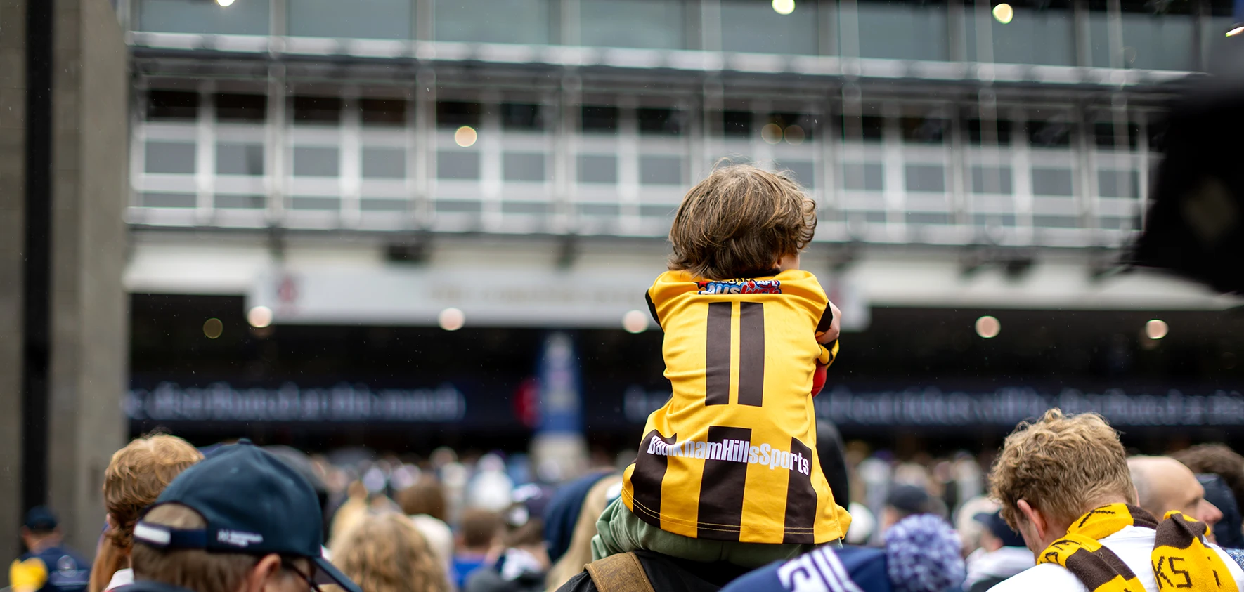 Junior Hawthorn supporter waits in front of Gate 2