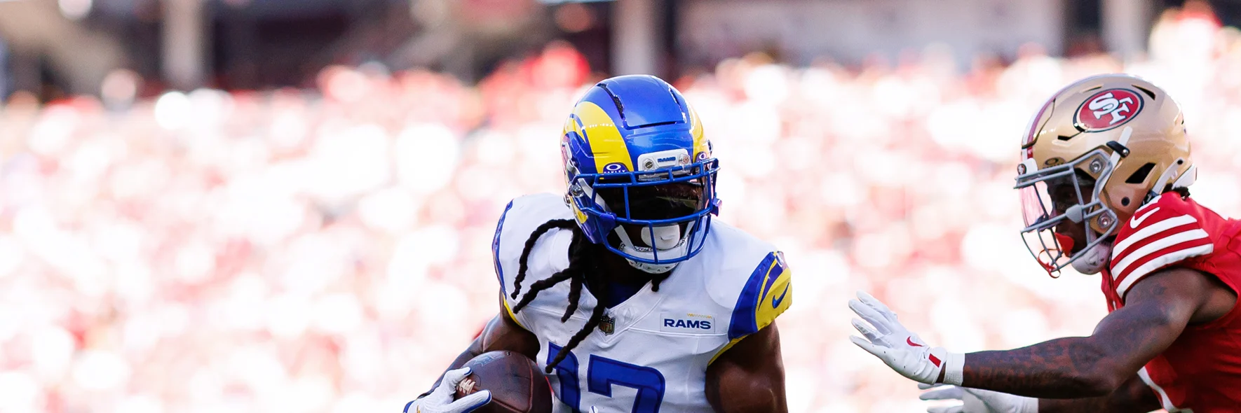 A Los Angeles Rams and San Francisco 49ers player on field during an NFL match