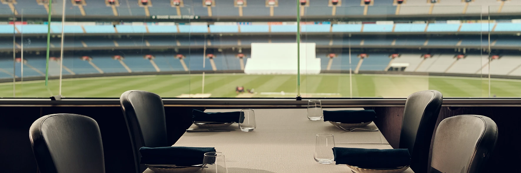Restaurant table with view of MCG arena through glass