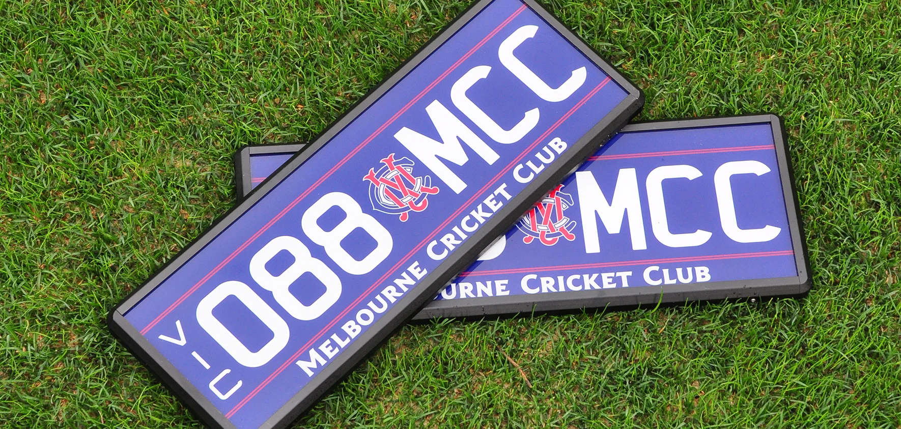 088.MCC number plate with navy background, white lettering, red detailing and logo