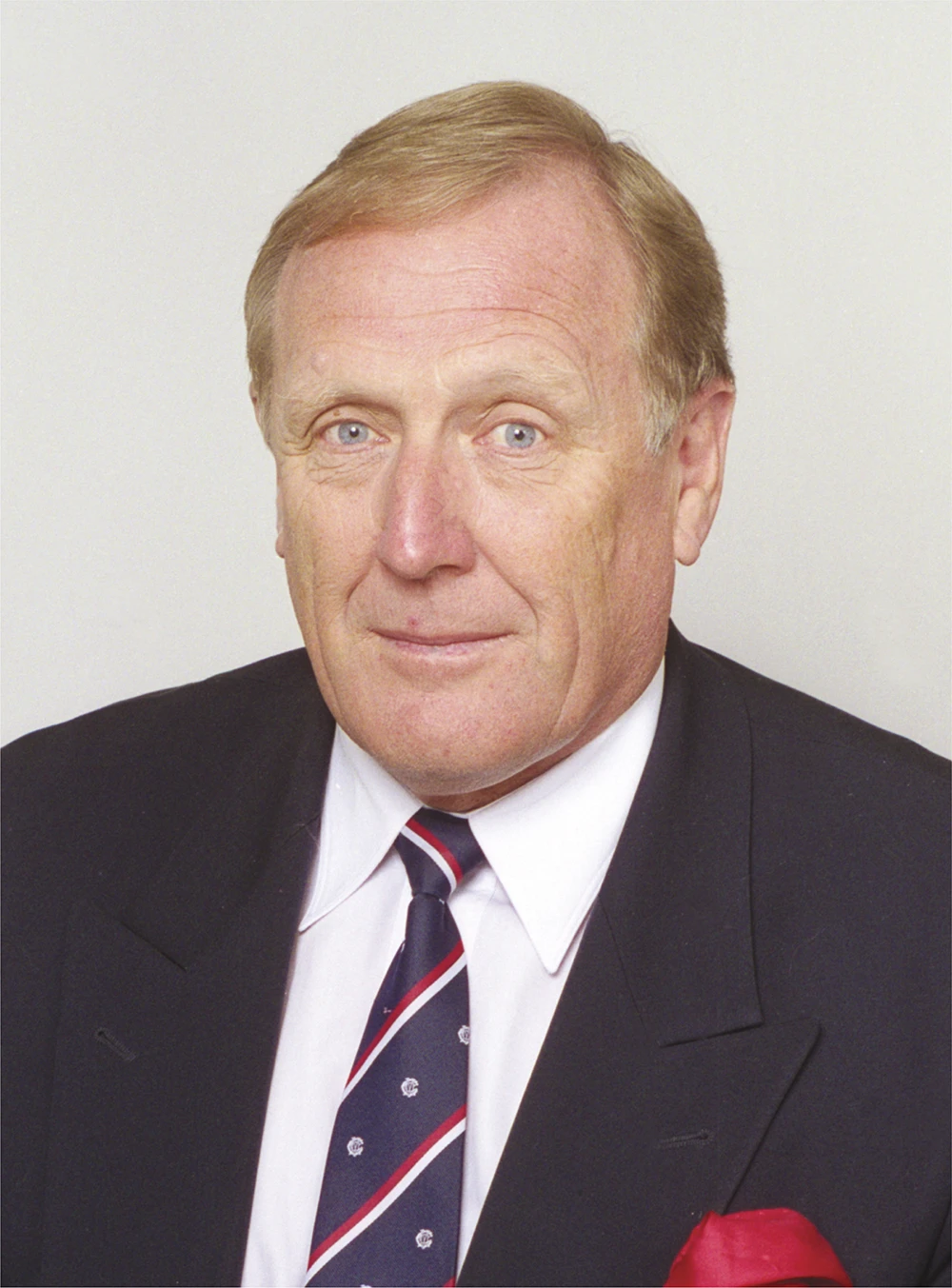 Headshot of Peter Mitchell. He wears an MCC tie