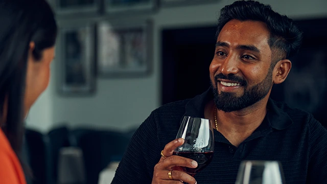 Guest enjoying a glass of red wine