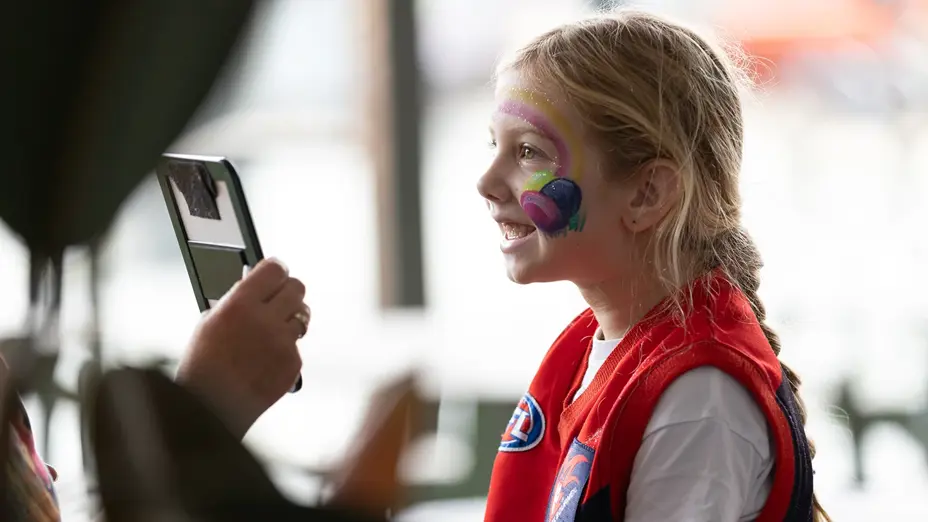 Young Melbourne footy fan at face painting