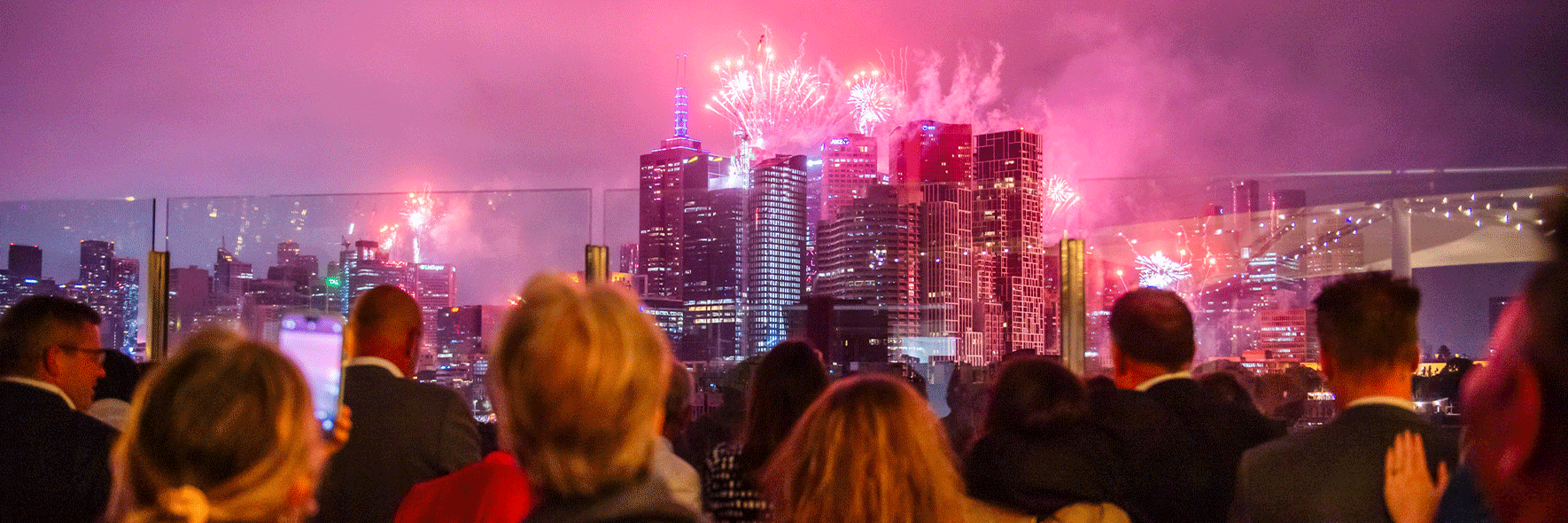 Crowd watching fireworks over the Melbourne city skyline