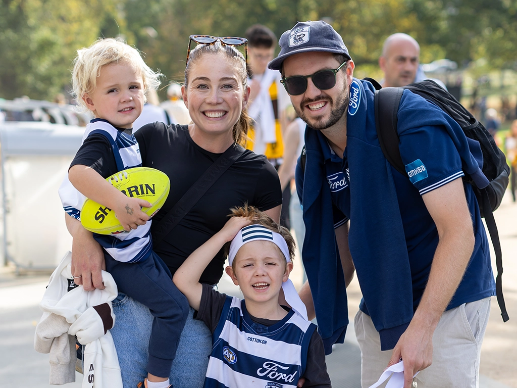 A family before a Geelong Cats match at the MCG AFL25RD6_GEELvHAW_095_MCC CTA desktop_1024x768.webp